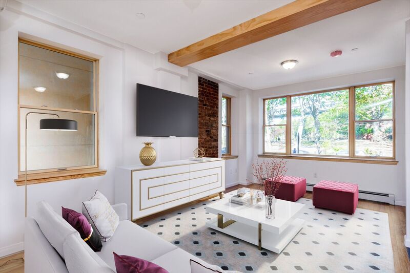 18-10 Astoria Park South, Unit 1 Queens, NY 11102 - Photo 3 of 7 a living room with furniture and a flat screen tv