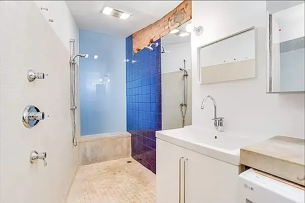 20 Renwick Street, Unit AB Manhattan, NY 10013 - Photo 5 of 9 a bathroom with a sink a toilet a mirror and shower