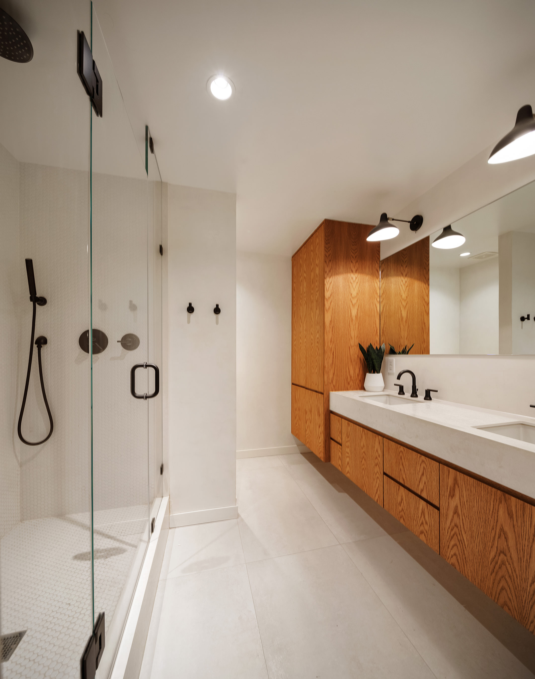 169 Mercer Street, Unit 2 Manhattan, NY 10012 - Photo 6 of 10 a bathroom with a double vanity sink mirror and shower