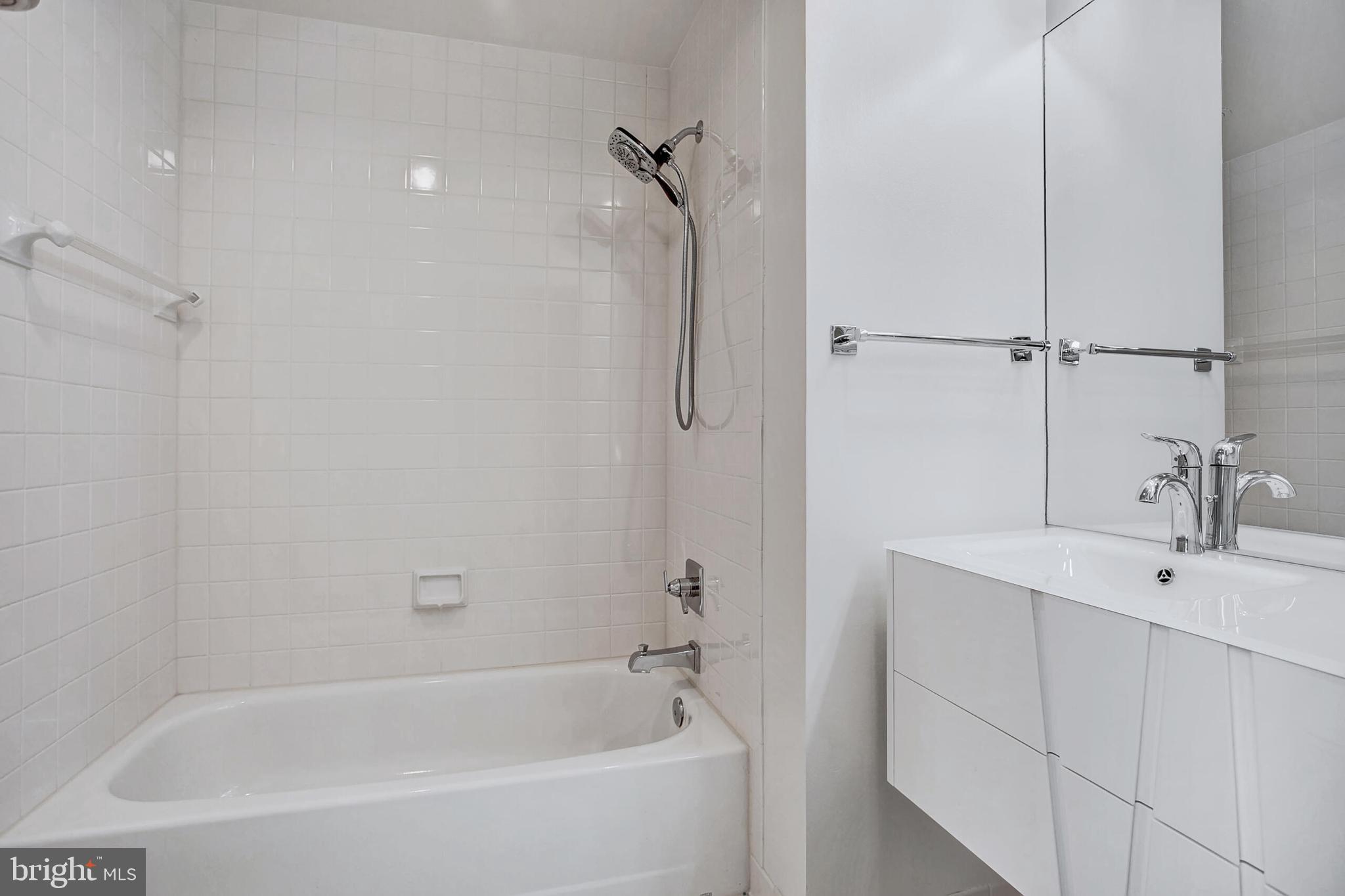 4709 Foxhall Crescent Northwest Washington, DC 20007 - Photo 48 of 57 a white bath tub sitting next to a white sink