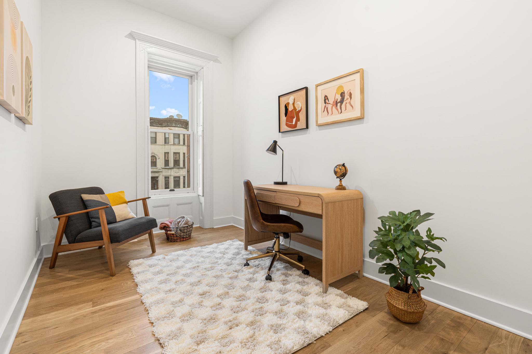 987 Sterling Place Brooklyn, NY 11213 - Photo 7 of 16 a living room with furniture a potted plant and a window