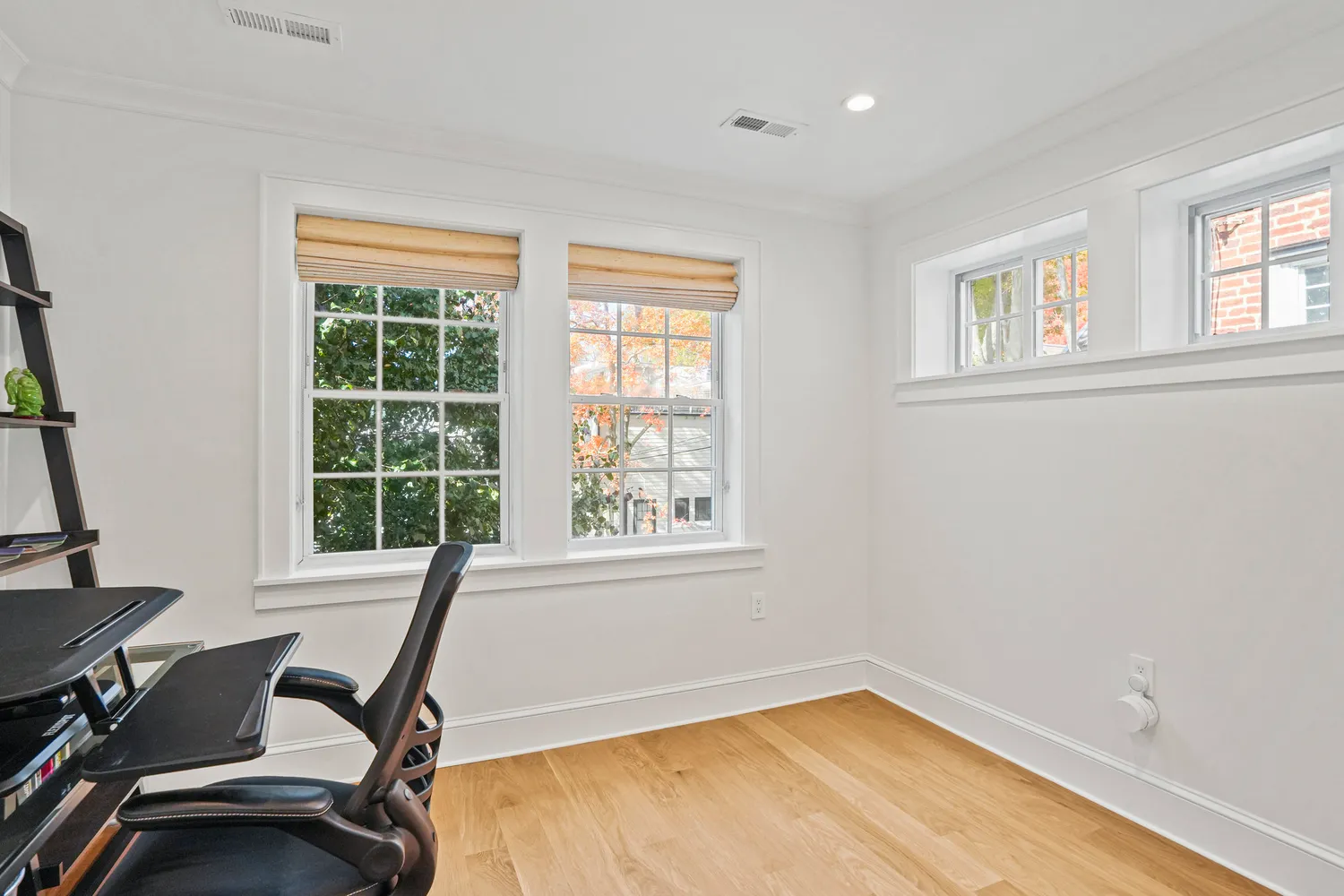 a view of a workspace with furniture and wooden floor