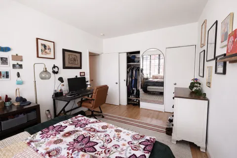 a bedroom with furniture and a rug