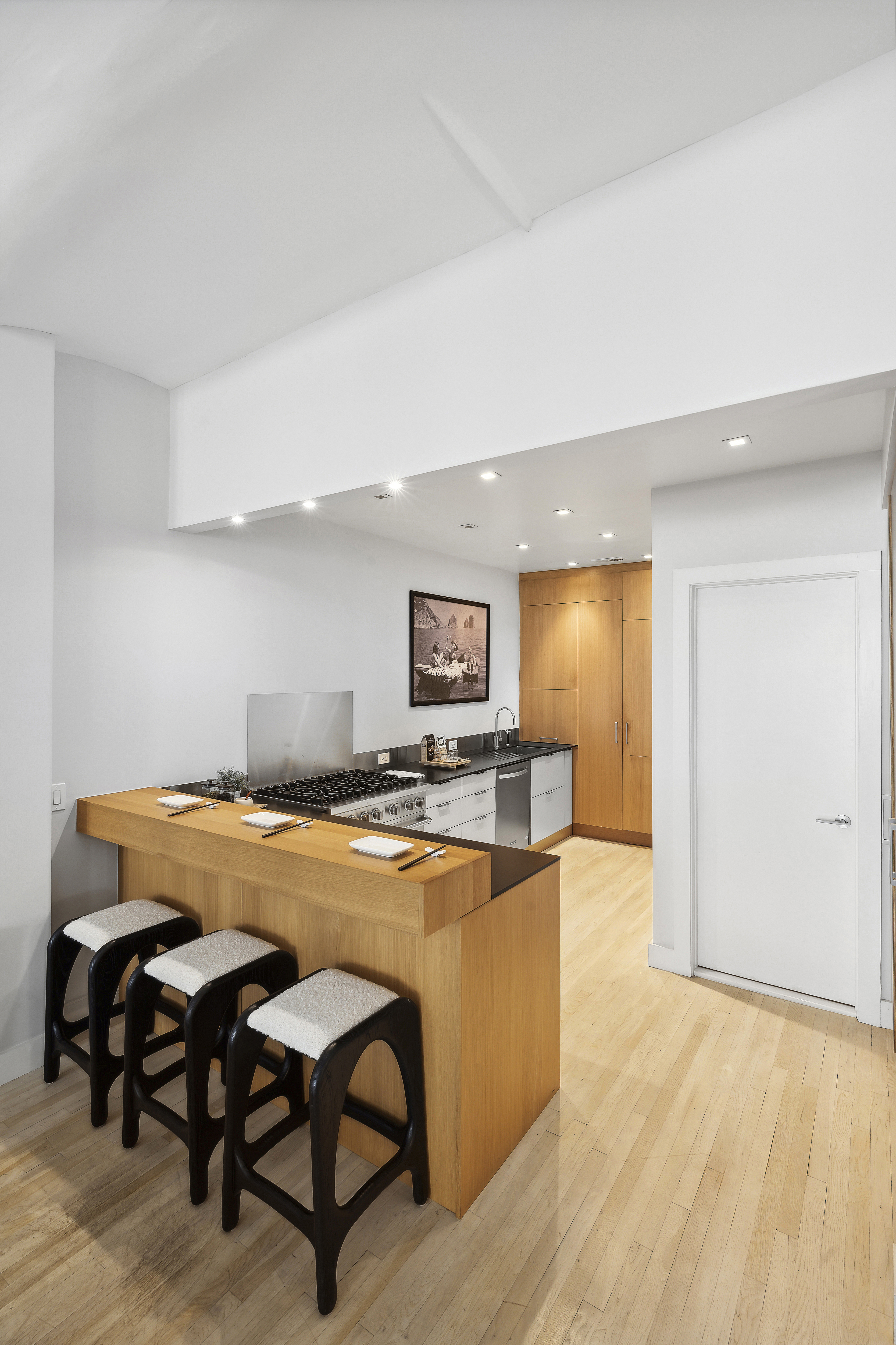 4 West 16th Street, Unit 4A Manhattan, NY 10011 - Photo 6 of 11 a dining hall with a dining table and chairs with wooden floor