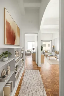 a living room with furniture and a kitchen view