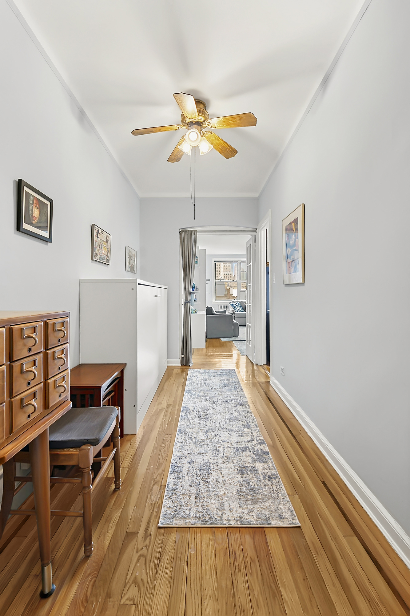 310 West 55th Street, Unit 6K Manhattan, NY 10019 - Photo 3 of 7 a living room with furniture and a wooden floor