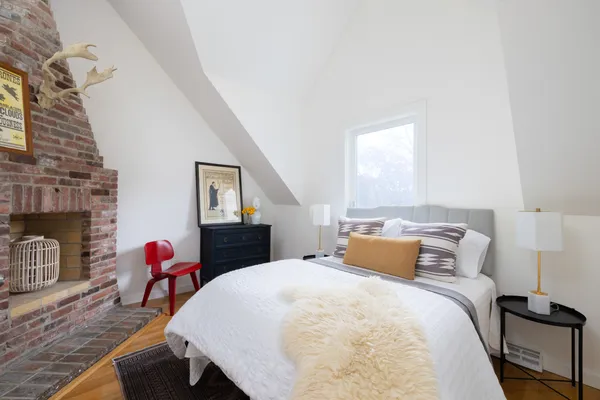 a bedroom with a bed and a fireplace