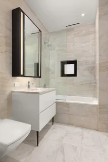 a bathroom with a sink a toilet and mirror