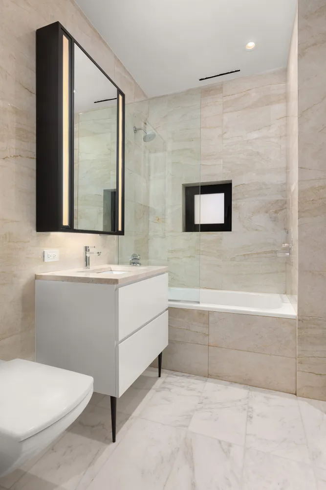 a bathroom with a sink a toilet and mirror