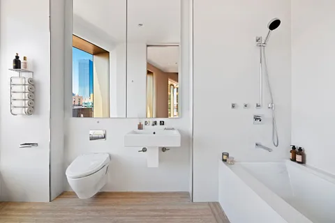 a bathroom with a toilet a sink and bathtub