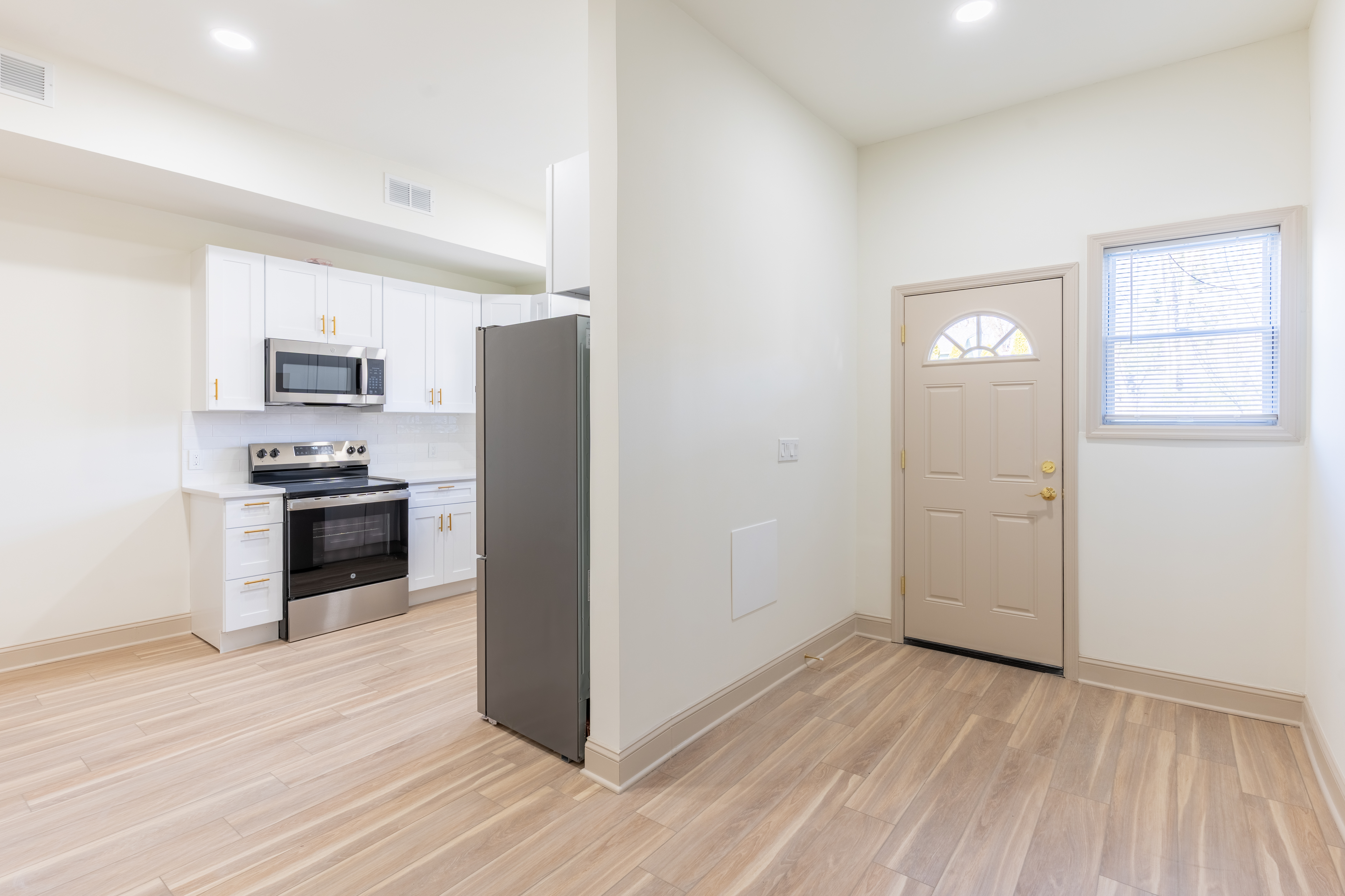 415 North Haddon Avenue Haddonfield, NJ 08033 - Photo 20 of 23 a kitchen with granite countertop a refrigerator and a stove top oven