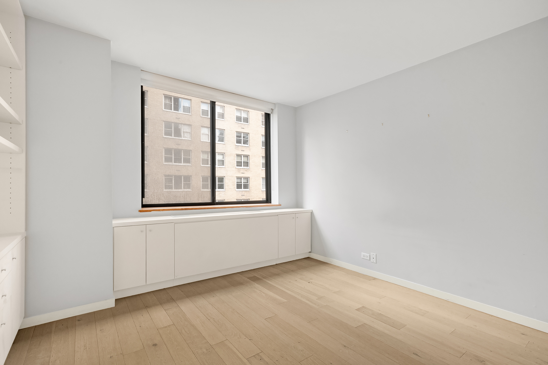 330 East 75th Street, Unit 3L Manhattan, NY 10021 - Photo 9 of 14 an empty room with windows