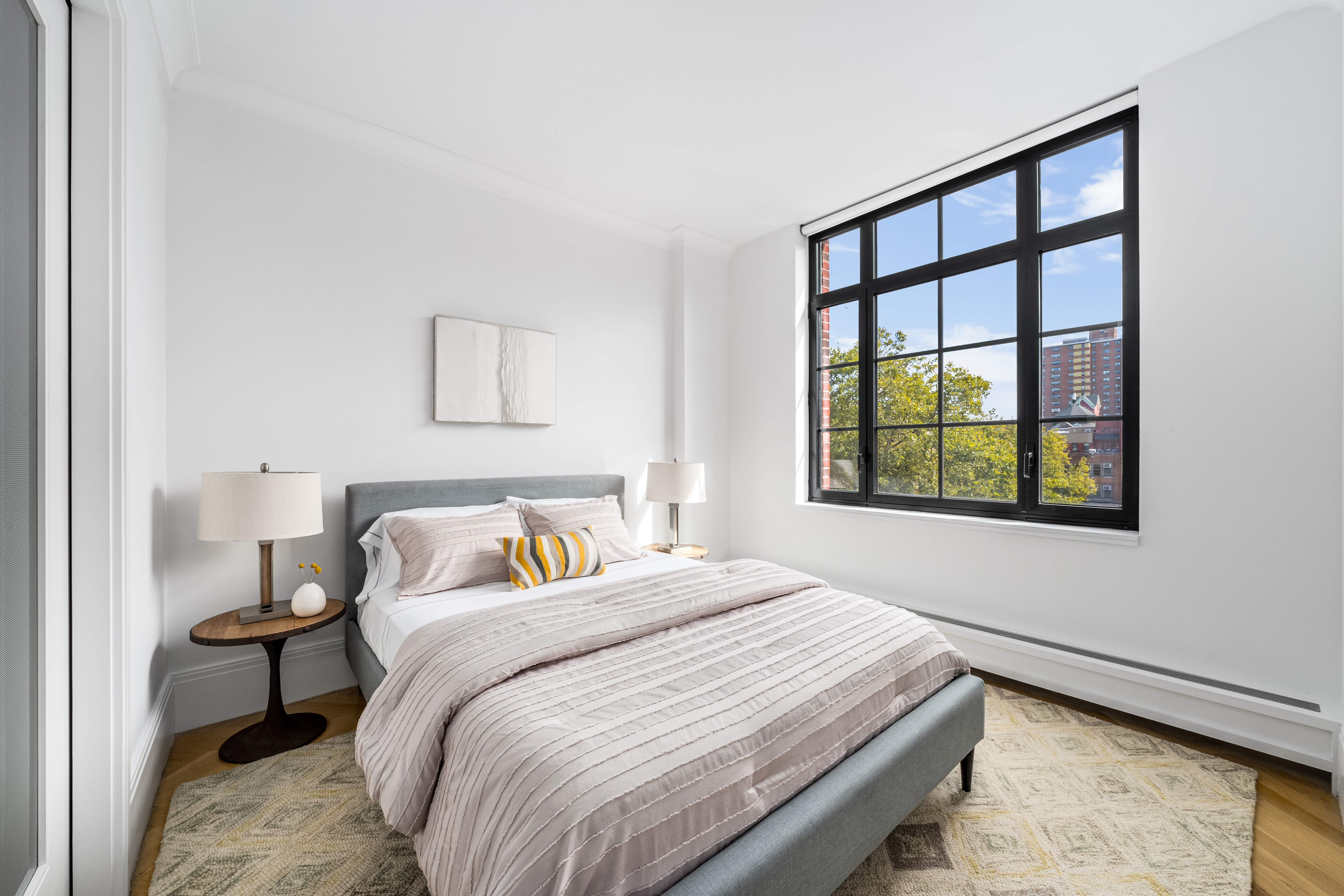 50 Clinton Street, Unit 4A Manhattan, NY 10002 - Photo 4 of 12 a bedroom with a bed and a window