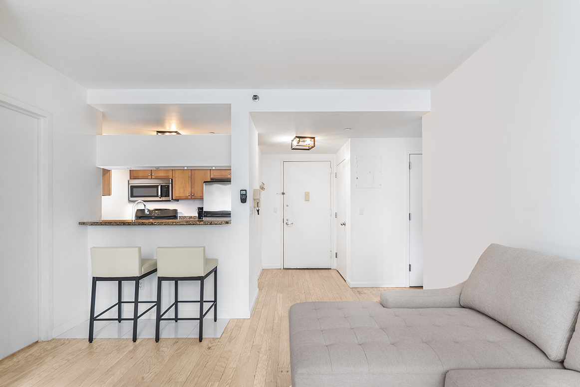 520 West 23rd Street, Unit 9D Manhattan, NY 10011 - Photo 2 of 10 a bedroom with a bed and furniture