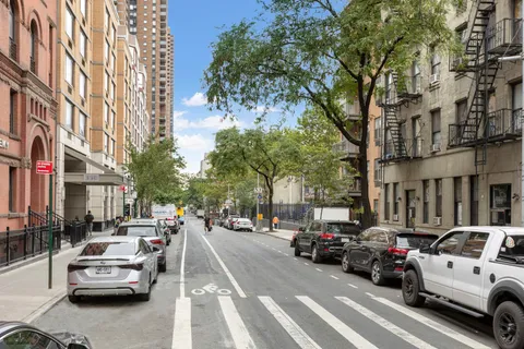a view of a cars park in front of a building