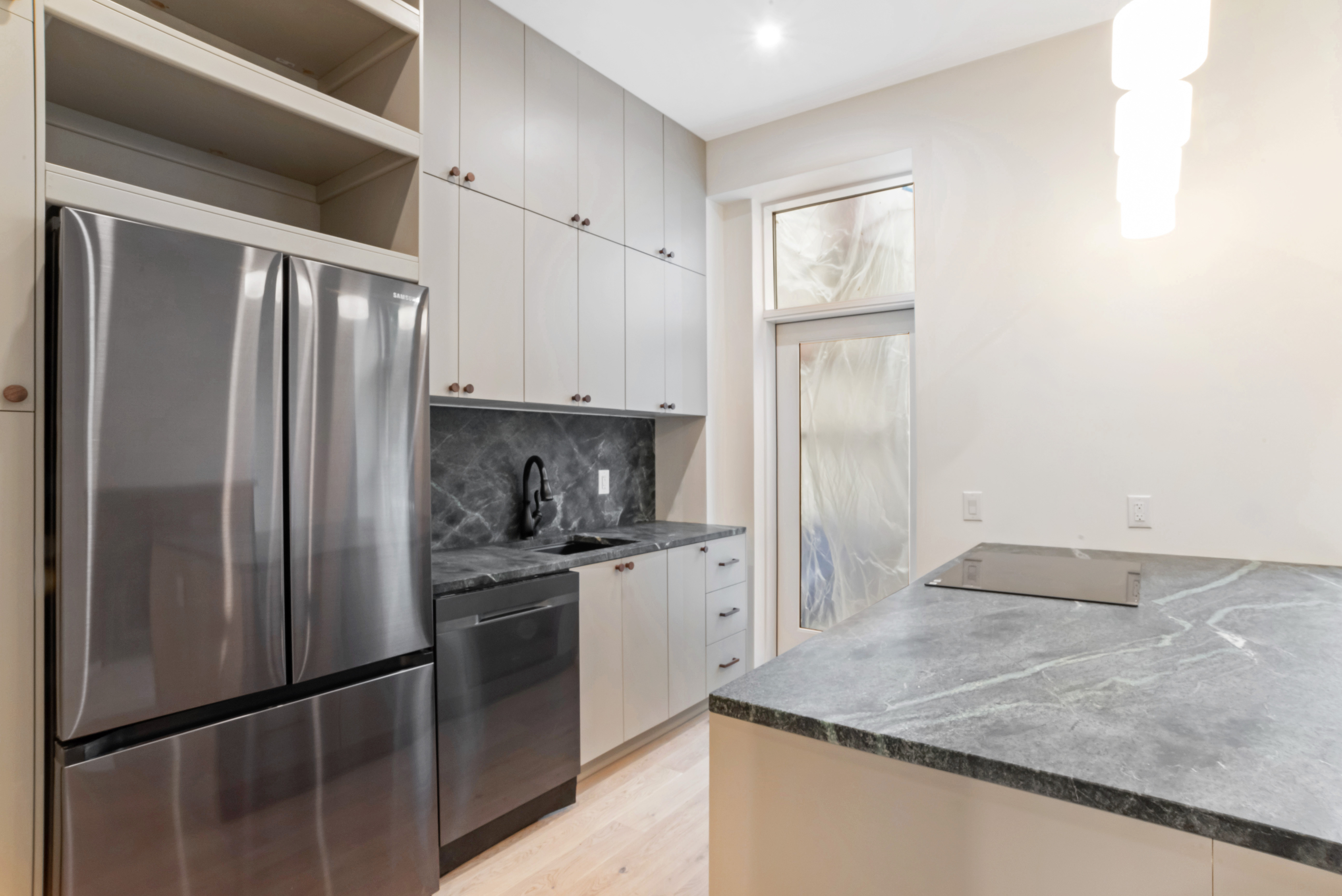 42 Monroe Street, Unit 2 Brooklyn, NY 11238 - Photo 5 of 19 a kitchen with granite countertop a refrigerator and a sink