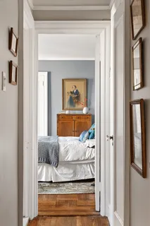 a living room with furniture and a painting on the wall