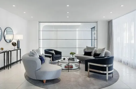 a living room with furniture a air conditioner and a window