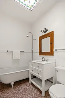 a bathroom with a toilet a sink and bathtub