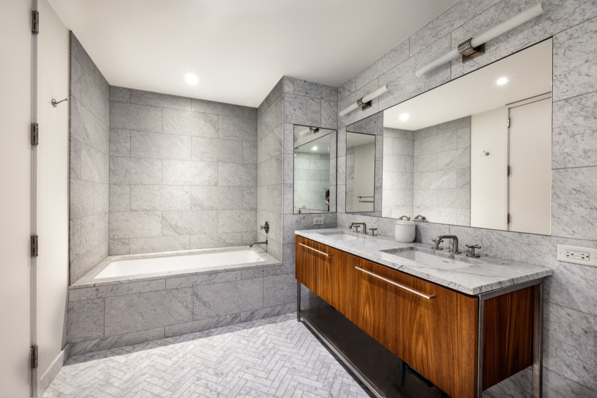 90 Furman Street, Unit N208 Brooklyn, NY 11201 - Photo 9 of 23 a bathroom with a tub sink shower and mirror