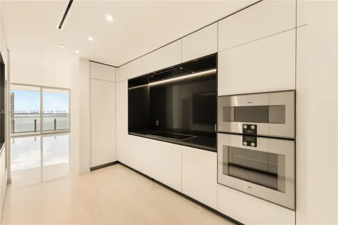 a hallway view with large mirror and window