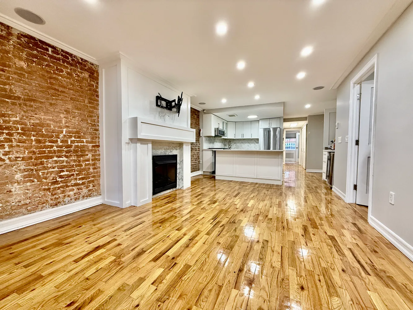 a large kitchen with cabinets and wooden floor