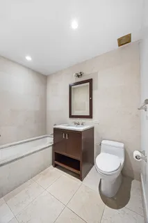 a bathroom with a toilet a sink and bathtub
