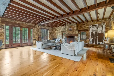 a room with pool table and wooden floor