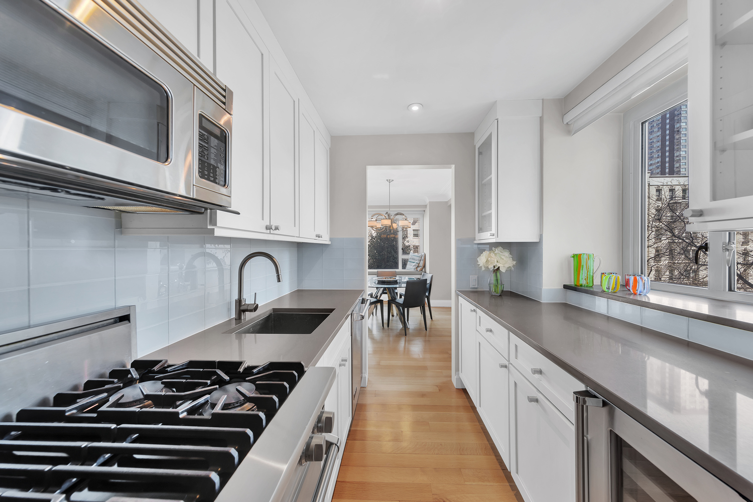 200 East 66th Street, Unit A407 Manhattan, NY 10065 - Photo 4 of 24 a kitchen with sink and stove