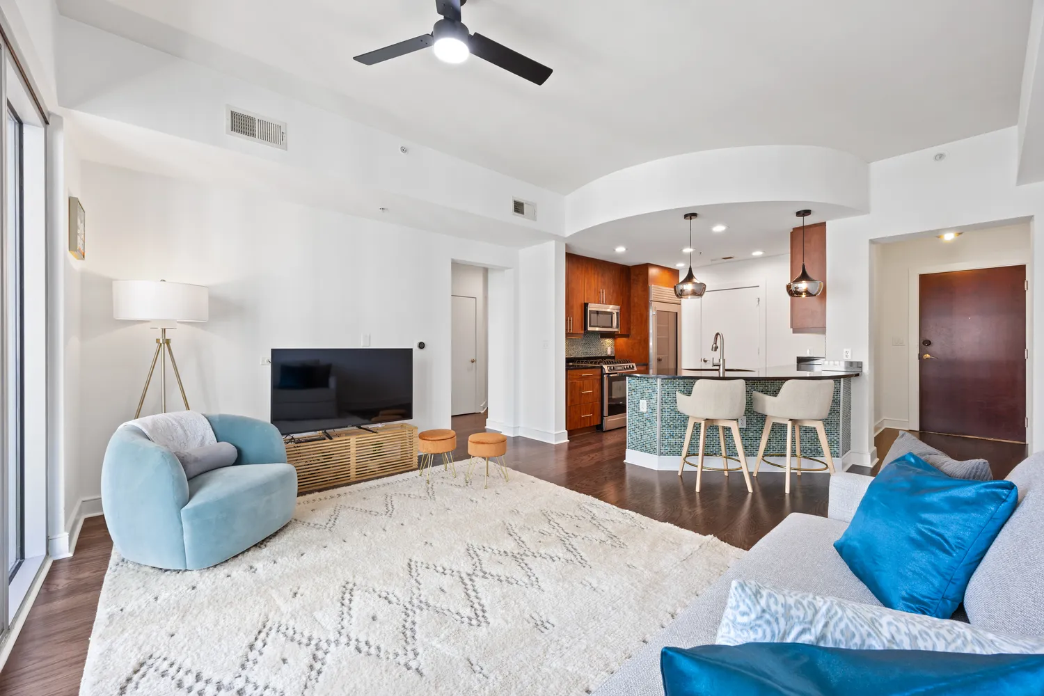 a large bedroom with a bed and a flat screen tv