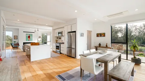 a living room with furniture a refrigerator and dining table