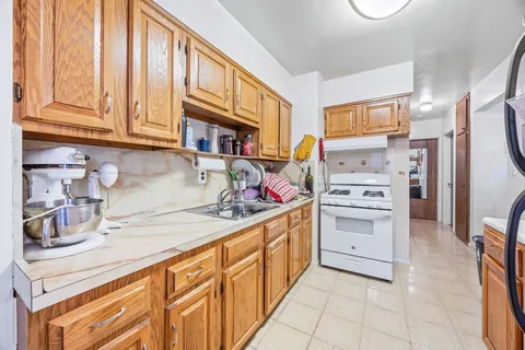 a kitchen with stainless steel appliances a stove a sink and a refrigerator