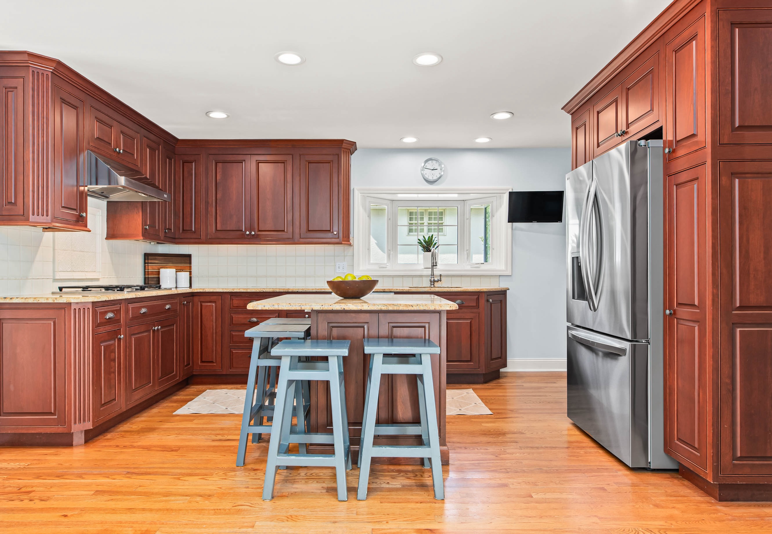 1136 Seaton Ross Road Wayne, PA 19087 - Photo 14 of 48 a kitchen with kitchen island granite countertop wooden floors stainless steel appliances and cabinets