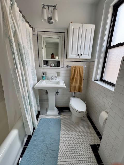 457 West 57th Street, Unit 1712 Manhattan, NY 10019 - Photo 6 of 9 a bathroom with a toilet sink and mirror