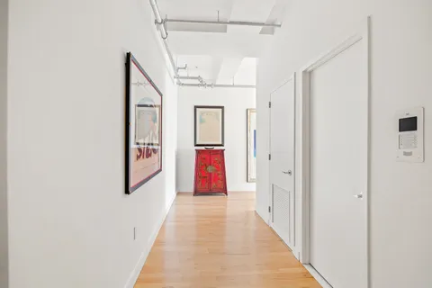 a view of a hallway with wooden floor