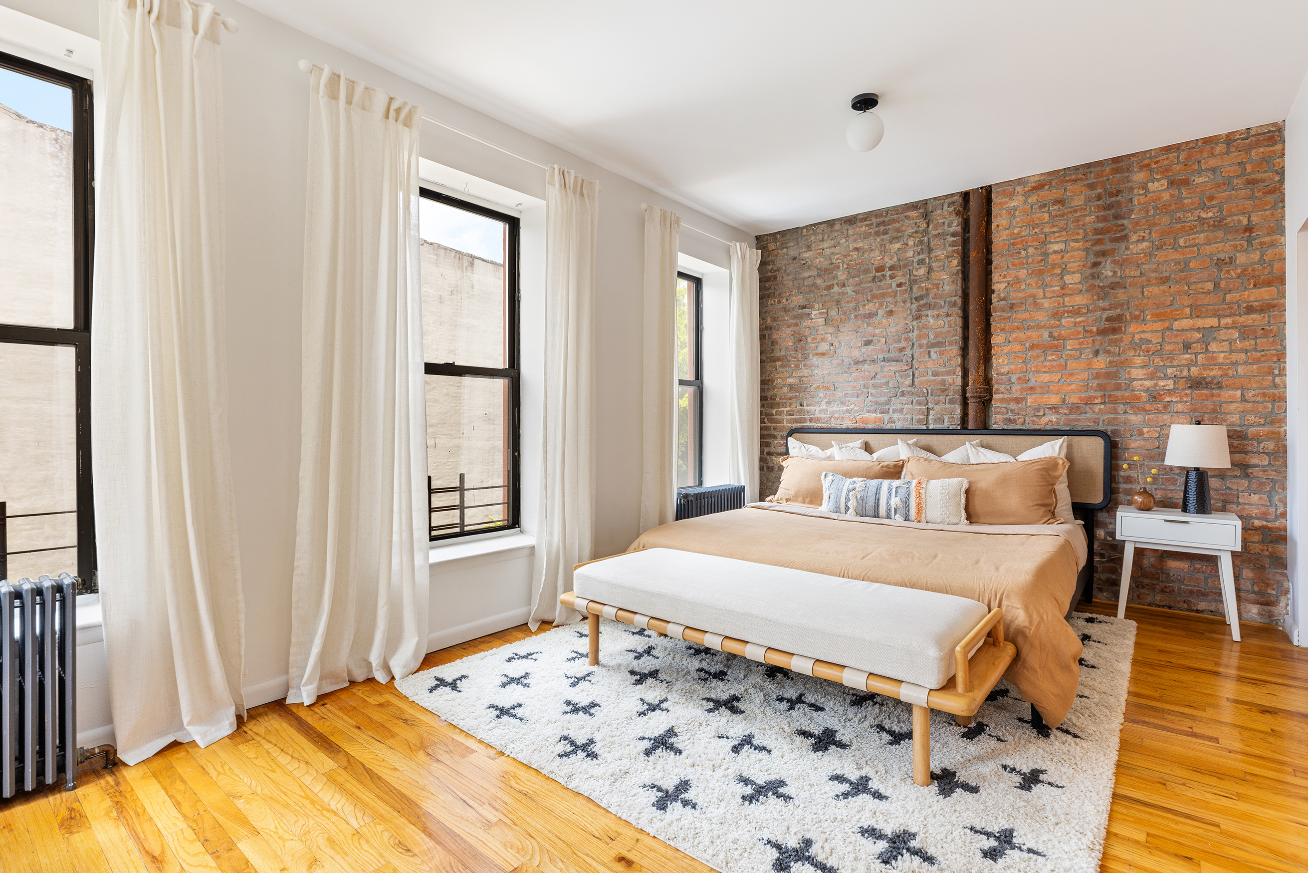 412 Classon Avenue Brooklyn, NY 11238 - Photo 15 of 30 a bedroom with a bed and wooden floor