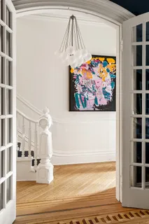 a view of a living room and a painting on the wall
