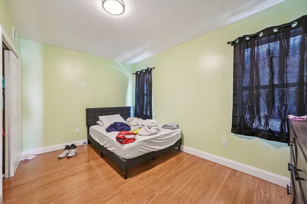 a bedroom with a bed and a window