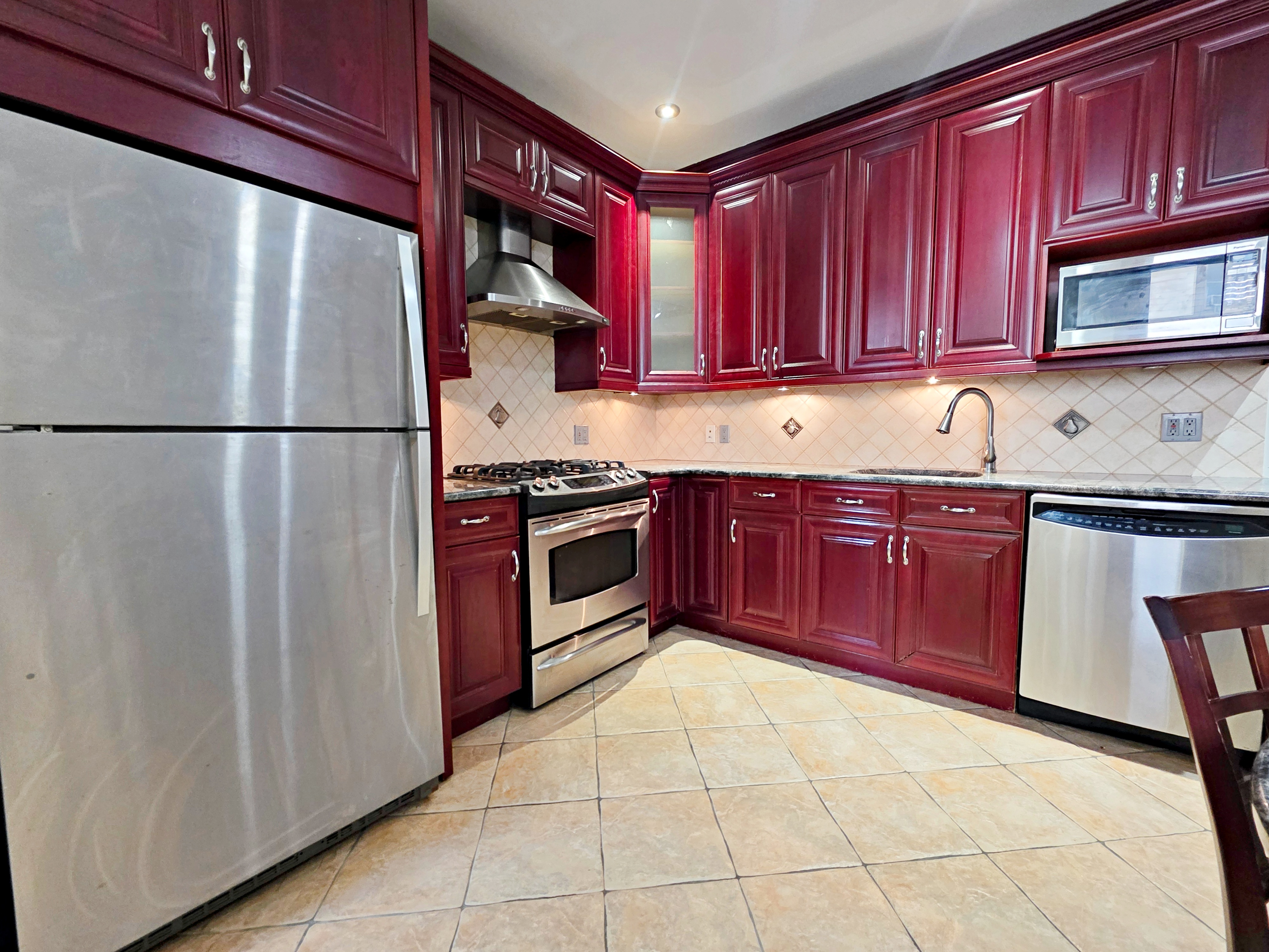 714 Lorimer Street, Unit 1 Brooklyn, NY 11211 - Photo 1 of 7 a kitchen with stainless steel appliances granite countertop a refrigerator stove a sink and dishwasher