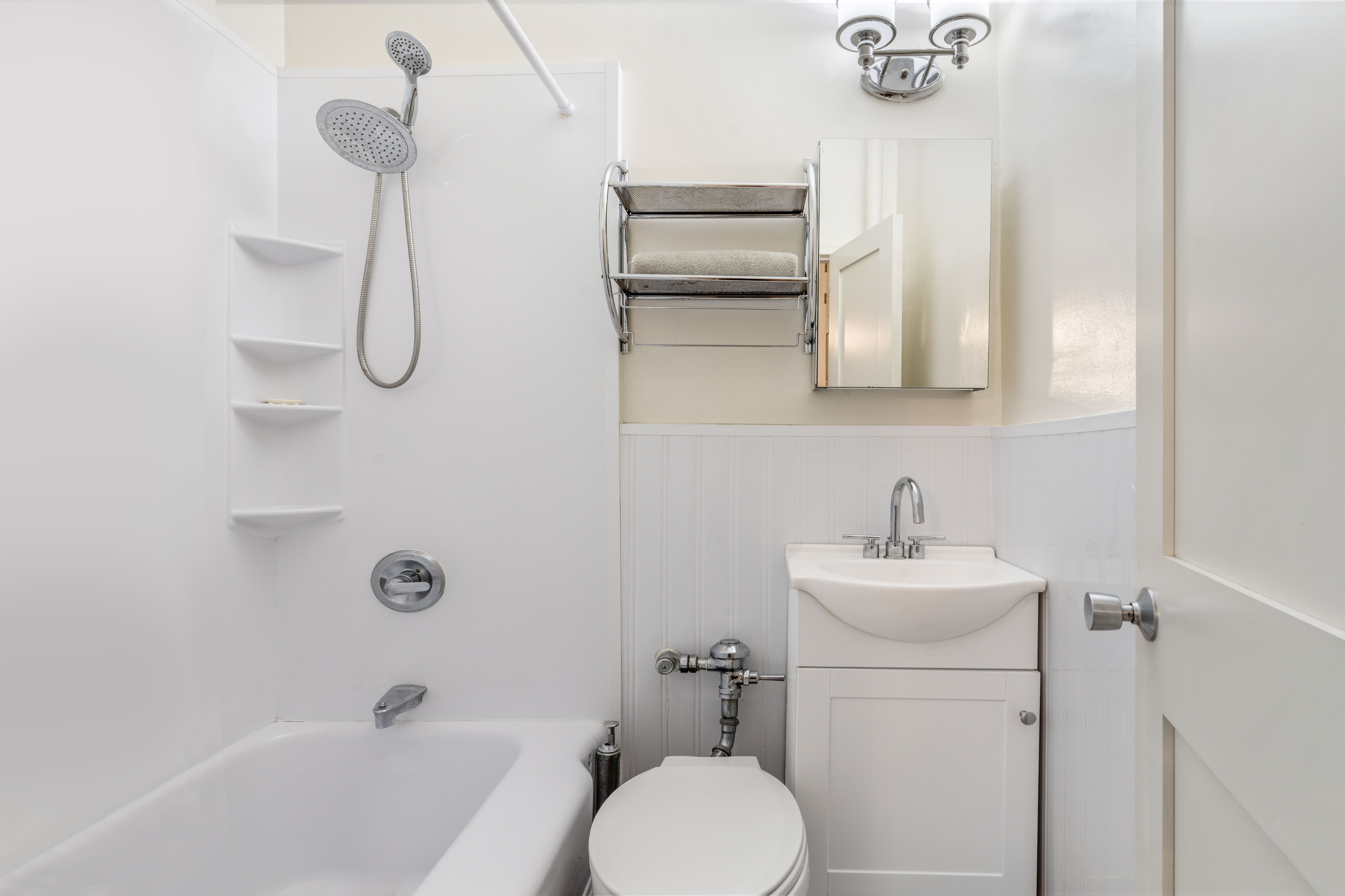 102 West 80th Street, Unit 55 Manhattan, NY 10024 - Photo 5 of 6 a bathroom with a sink a toilet and shower