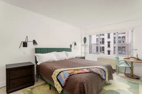 a bedroom with a bed and a cabinets