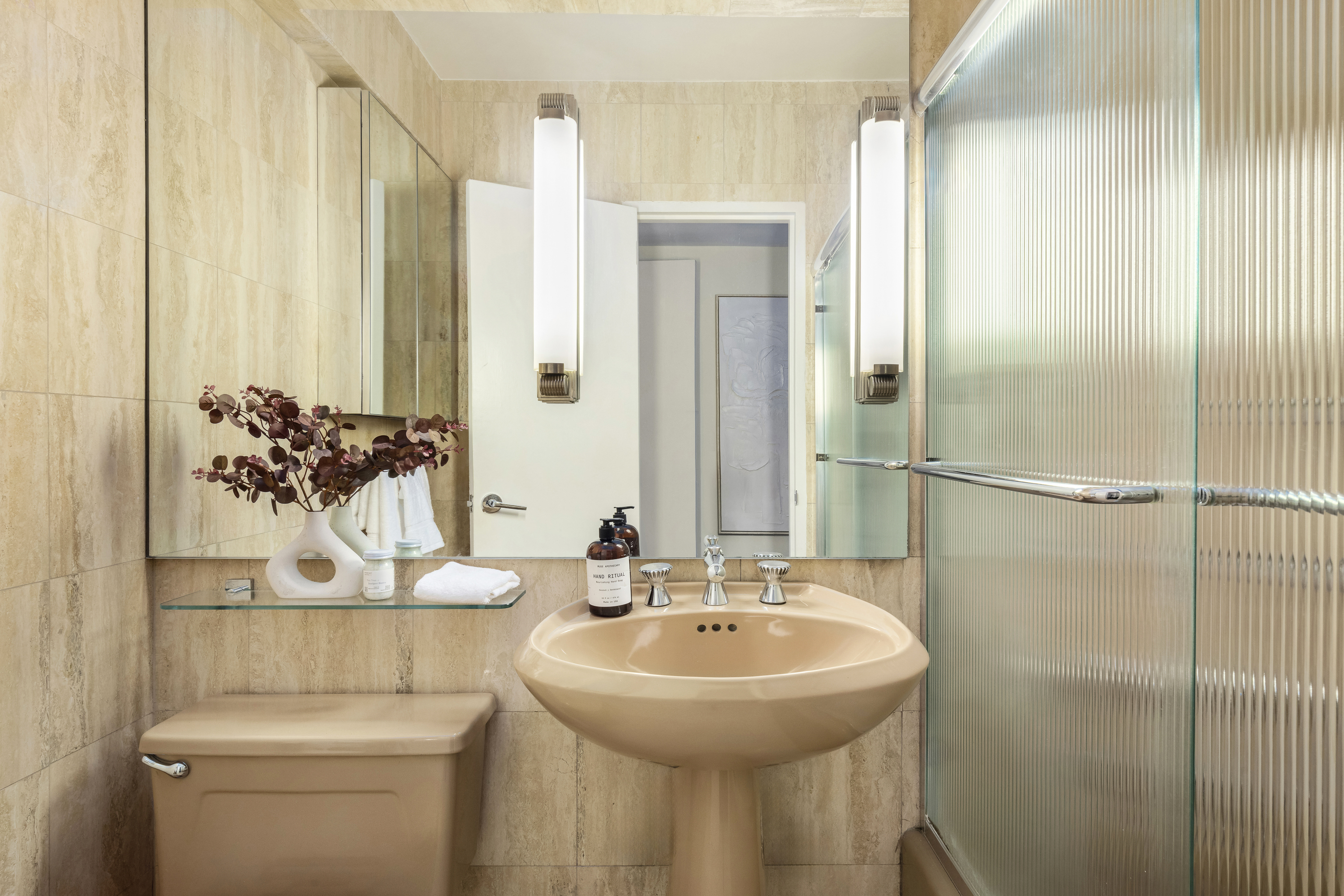 510 East 86th Street, Unit 17C Manhattan, NY 10028 - Photo 27 of 31 a bathroom with a sink toilet and mirror