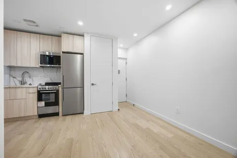 a kitchen with stainless steel appliances a refrigerator and a stove top oven
