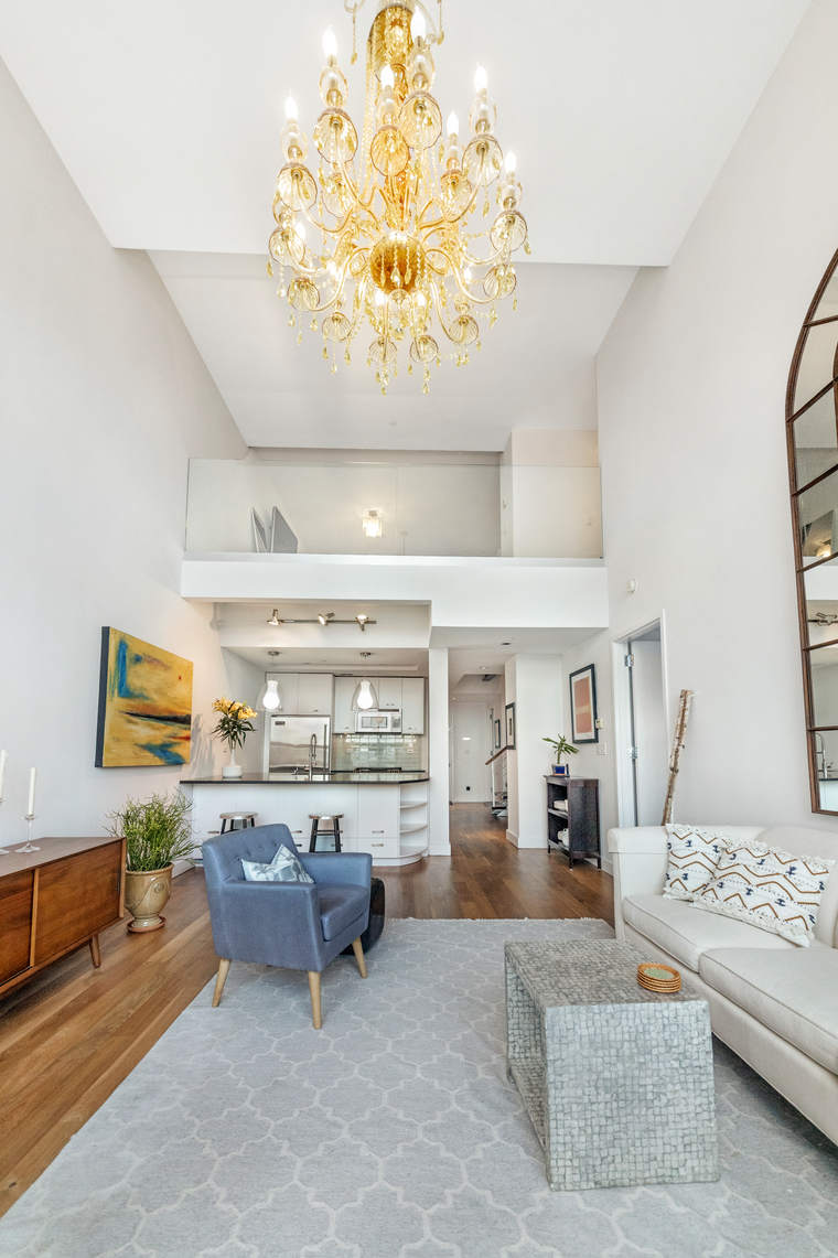 2-17 51st Avenue, Unit 606 Queens, NY 11101 - Photo 2 of 18 a living room with furniture and a chandelier