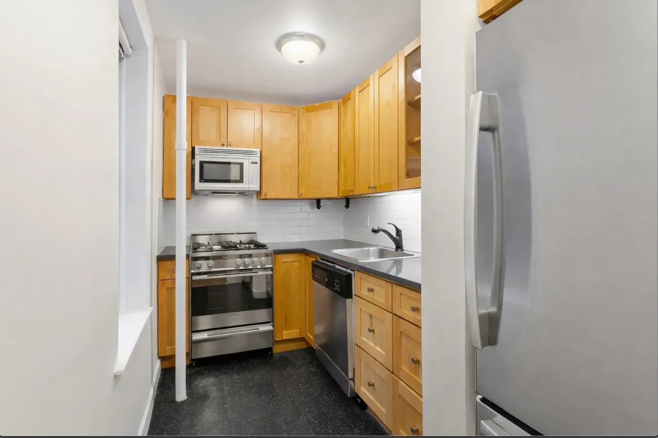 a kitchen with stainless steel appliances granite countertop a stove a sink and a microwave