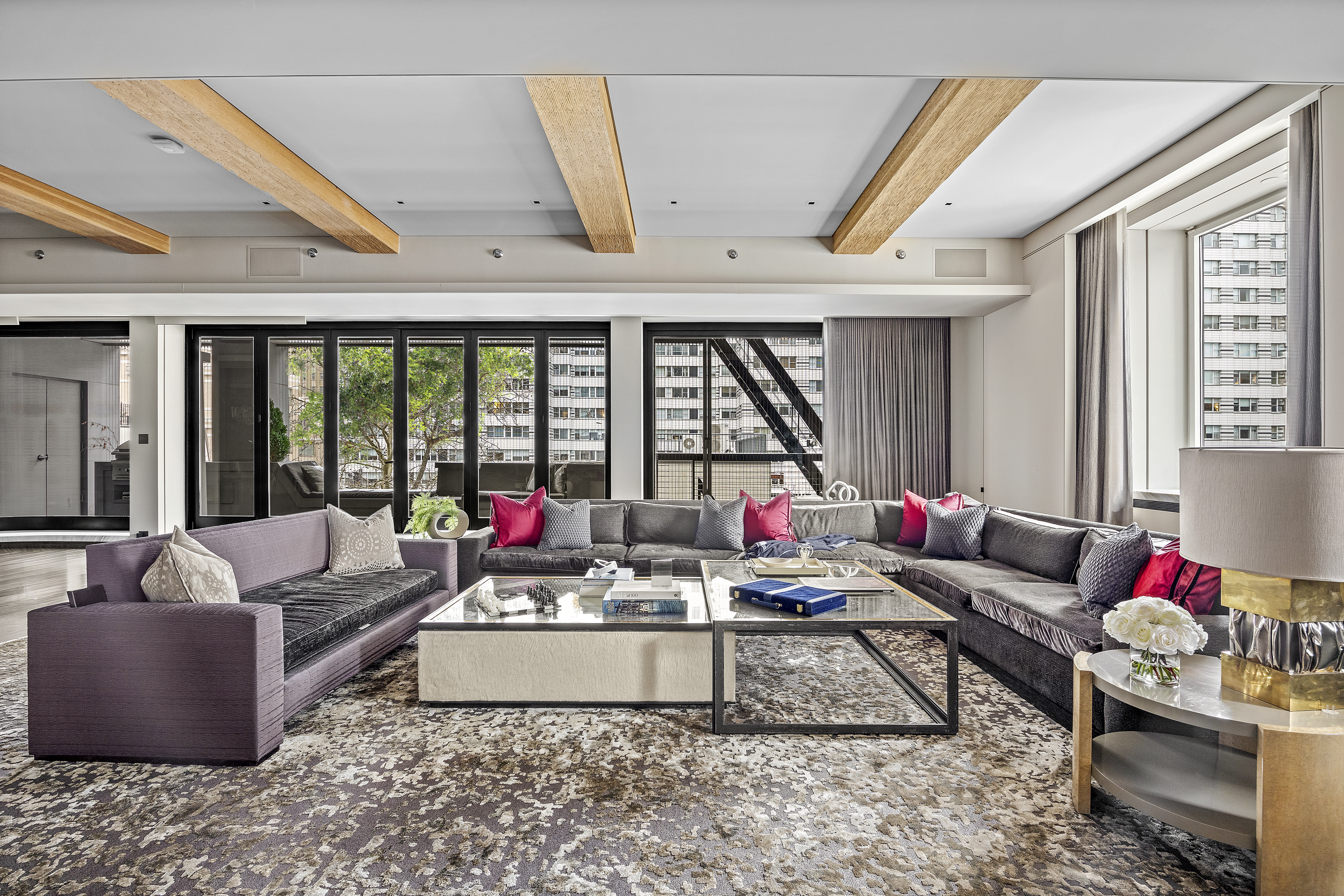 219 East 67th Street, Unit 5 Manhattan, NY 10065 - Photo 3 of 18 a living room with furniture and a large window