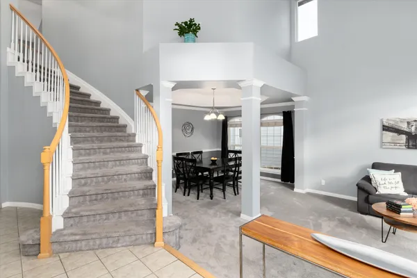 a view of a dining room and livingroom with furniture window and wooden floor