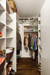 a view of walk in closet with clothes and shoes