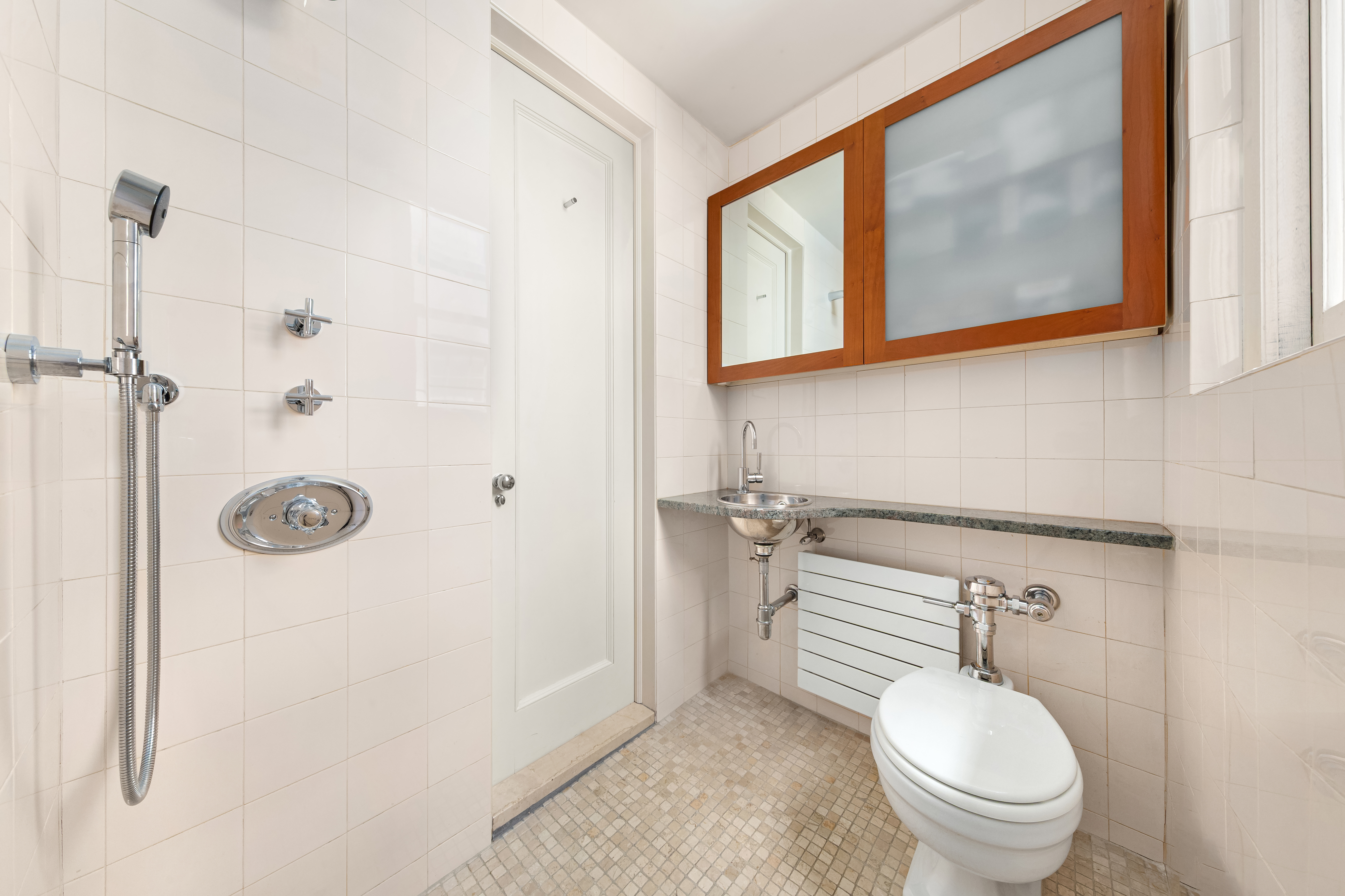 162 East 80th Street Manhattan, NY 10075 - Photo 12 of 13 a bathroom with a toilet sink and shower