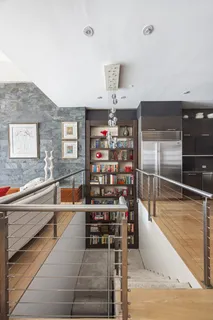 a room with lots of wooden furniture and a book shelf
